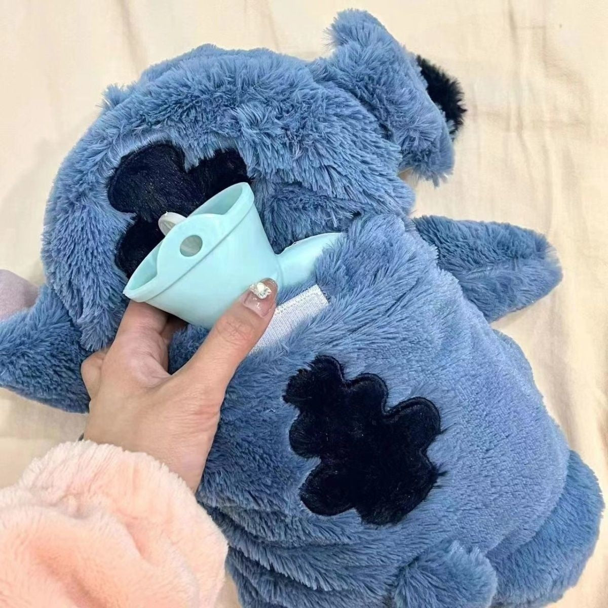 Plush Stitch with hot water bottle